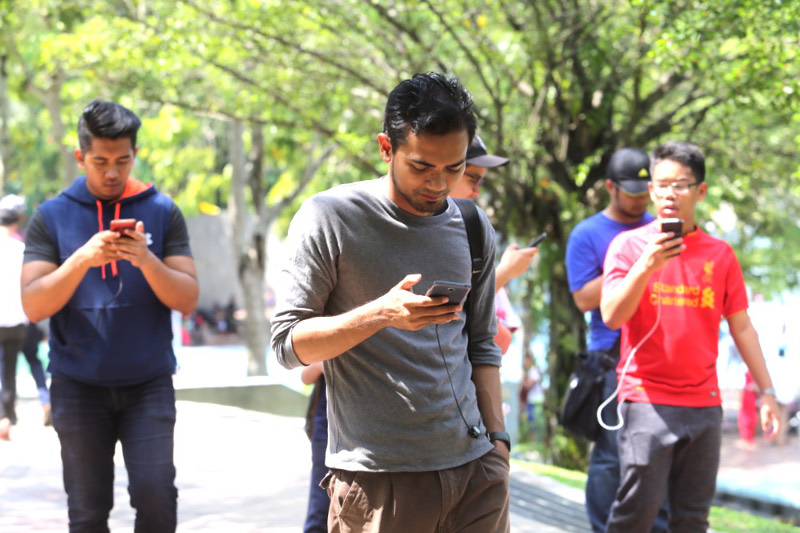 Pokemon Go players are seen trying to catch the cartoon monsters in KLCC park, August 7, 2016. u00e2u20acu201d Picture by Choo Choy May