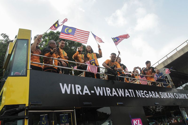 The Malaysian Olympic contingent on a bus during the National Day parade at Dataran Merdeka, Kuala Lumpur August 31, 2016. u00e2u20acu201d Picture by Mohd Yusof Mat Isa