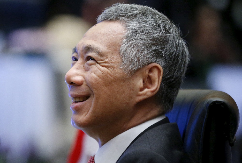 Singapore's Prime Minister Lee Hsien Loong talks with government officials during the Plenary session at the 27th Association of Southeast Asian Nations (ASEAN) summit in Kuala Lumpur, Malaysia, November 21, 2015. REUTERS/Olivia Harris/File Photo