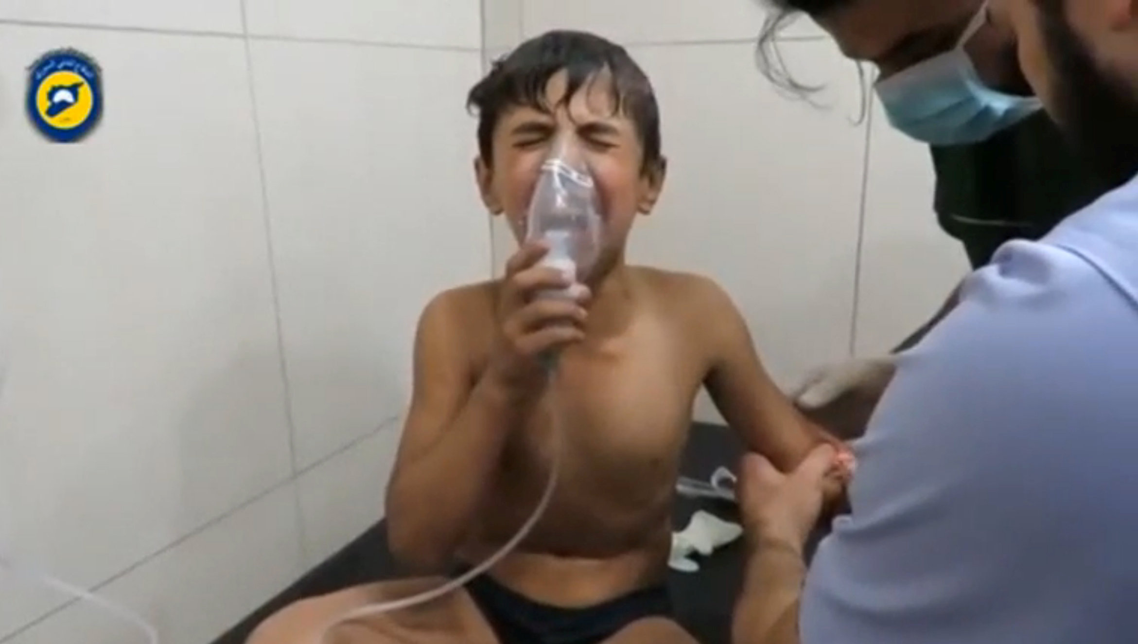 A still image taken on September 7, 2016 from a video posted on social media said to be shot in Aleppo's Al Sukari on September 6, 2016, shows a boy breathing with an oxygen mask inside a hospital, after a suspected chlorine gas attack, Syria. Social Medi