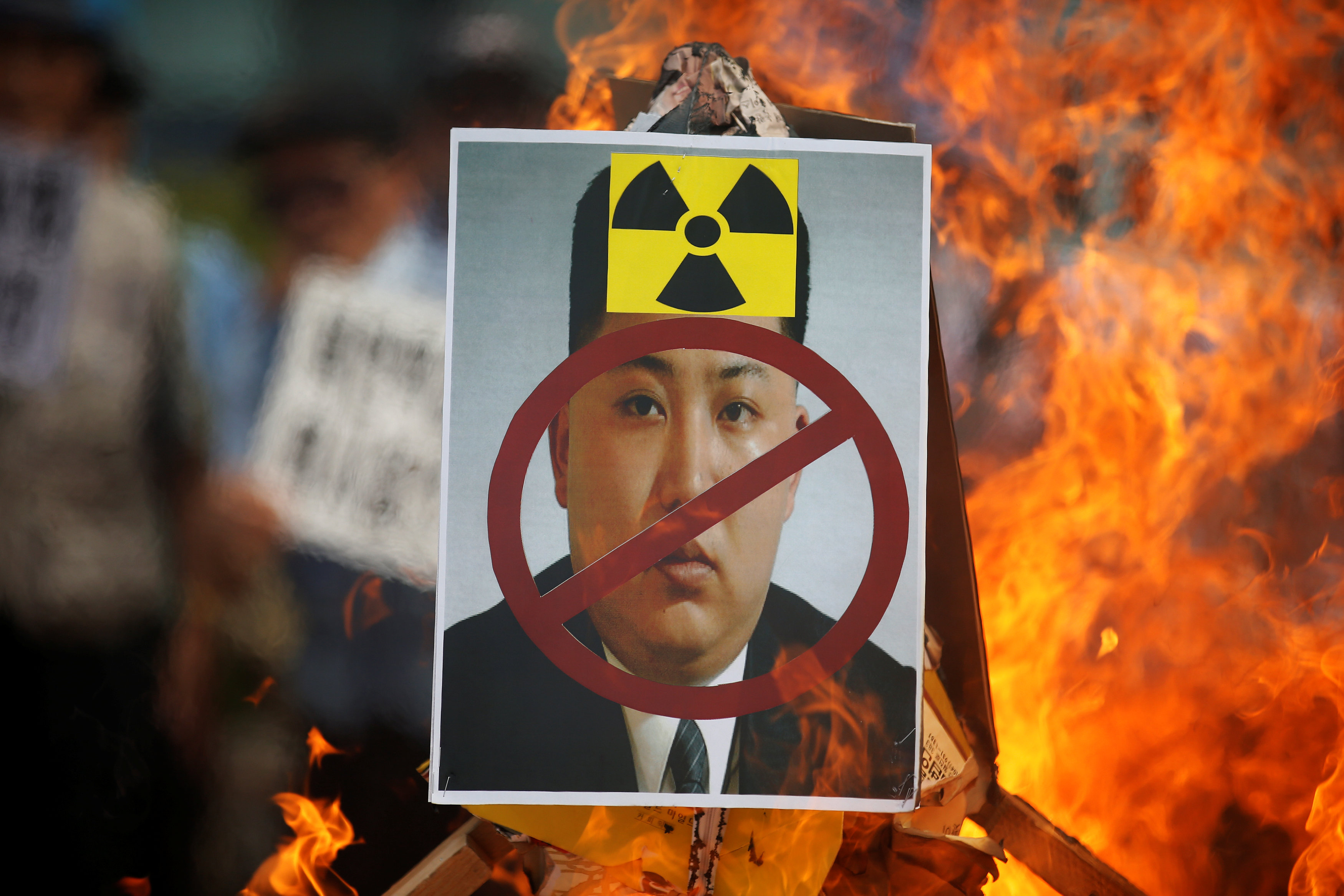A cut-out of North Korean leader Kim Jong Un is set on fire during an anti-North Korea rally in central Seoul, South Korea, September 10, 2016. REUTERS/Kim Hong-Jin