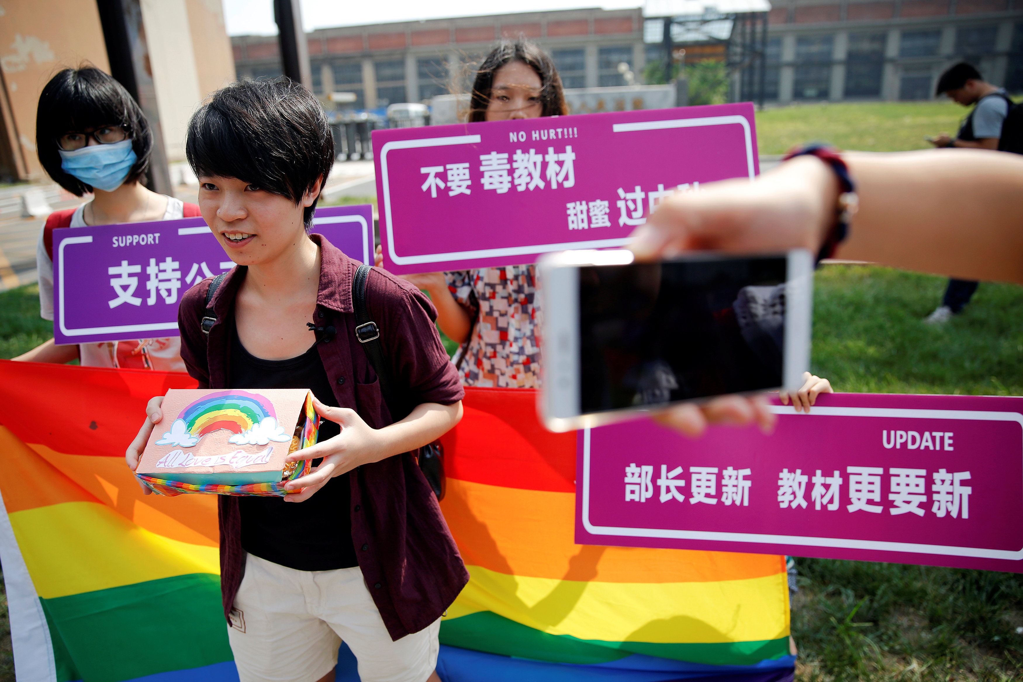 Qiu Bai, a Chinese student who lodged a suit against the Ministry of Education over school textbooks describing homosexuality as a mental disorder, shows the present she prepared for officials near the courthouse before the hearing in Beijing, China Septe