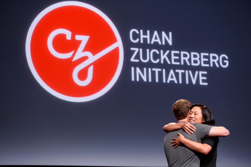 Pricilla Chan (R) embraces her husband Mark Zuckerberg while announcing the Chan Zuckerberg Initiative to ,cure, prevent or manage all disease, by the end of the century during a news conference at UCSF Mission Bay in San Francisco, California, U.S. Septe