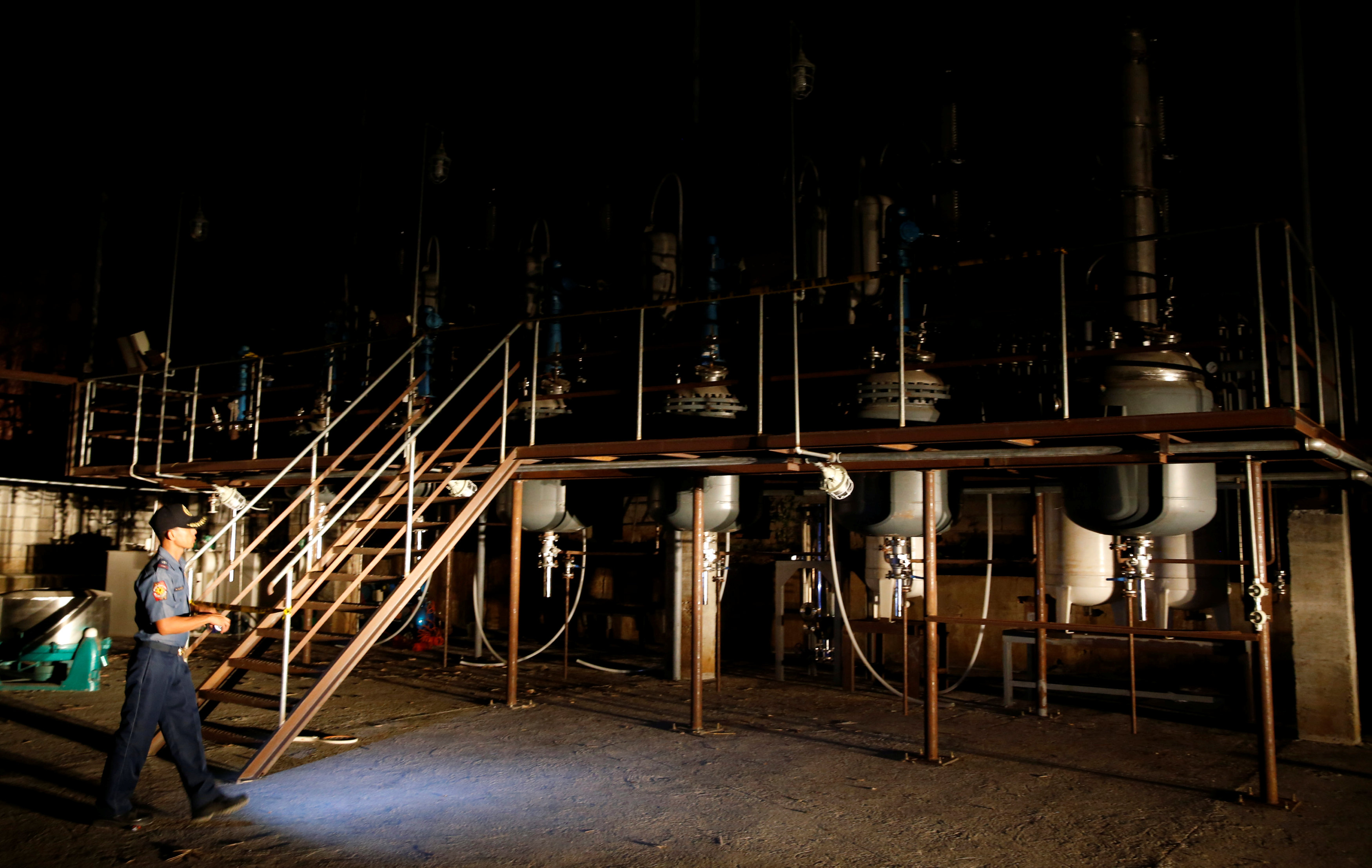 A policeman guards ,Shabu, (Meth) laboratory making equipment that was seized by government authorities, which drug enforcement officials said can make a daily production of about 100 kilos of ,Meth,, in a remote village in Arayat, Pampanga in northern Ph