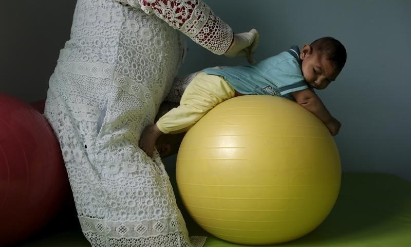 Physiotherapist Jeime Lara Leal does exercises with Lucas, 4-months old, who is Miriam Araujo's second child and born with microcephaly in Pedro I hospital in Campina Grande, Brazil , February 17, 2016. REUTERS/Ricardo Moraes/File Photo