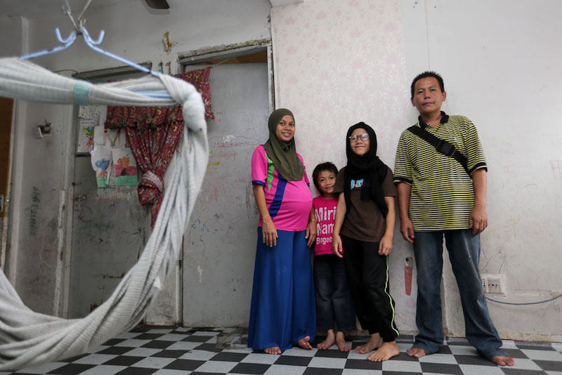 Rizal Ramli, Nor Azizah Karin and two of their seven children pose for a picture at their Kota Damansara PPR unit. u00e2u20acu201d Picture by Choo Choy May