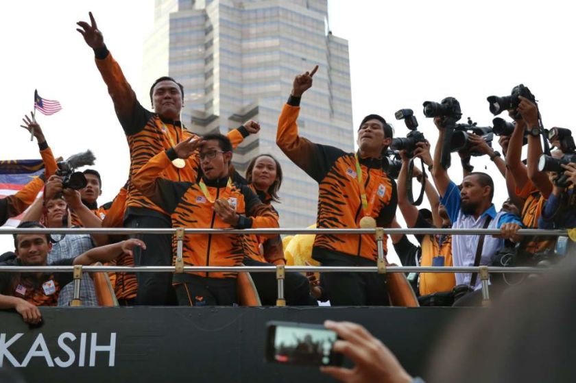Malaysiau00e2u20acu2122s Paralympics athletes are pictured in an open-top bus parade as they arrive at KLCC on September 22, 2016. u00e2u20acu2022 Picture by Saw Siow Feng