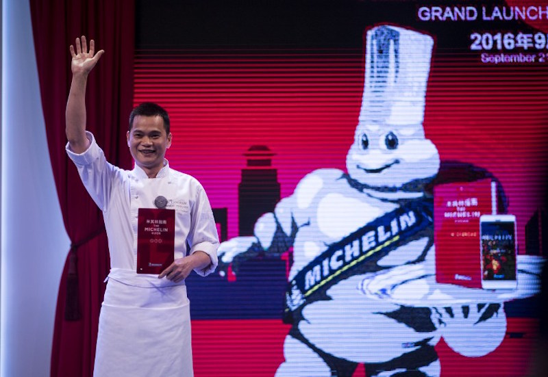 Master chef of Tu00e2u20acu2122ang Court, Justin Tan reacts on stage after the announcement of his three stars award of the Michelin Guide Shanghai September 21, 2016. u00e2u20acu201d AFP pic