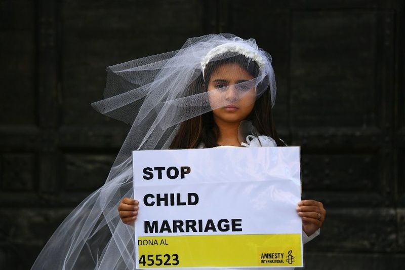 A young actress plays the role of Giorgia, 10, forced to marry Paolo, 47, during a happening organised by Amnesty International to denounce child marriage, on October 27, 2016 in Rome. u00e2u20acu2022 AFP pic