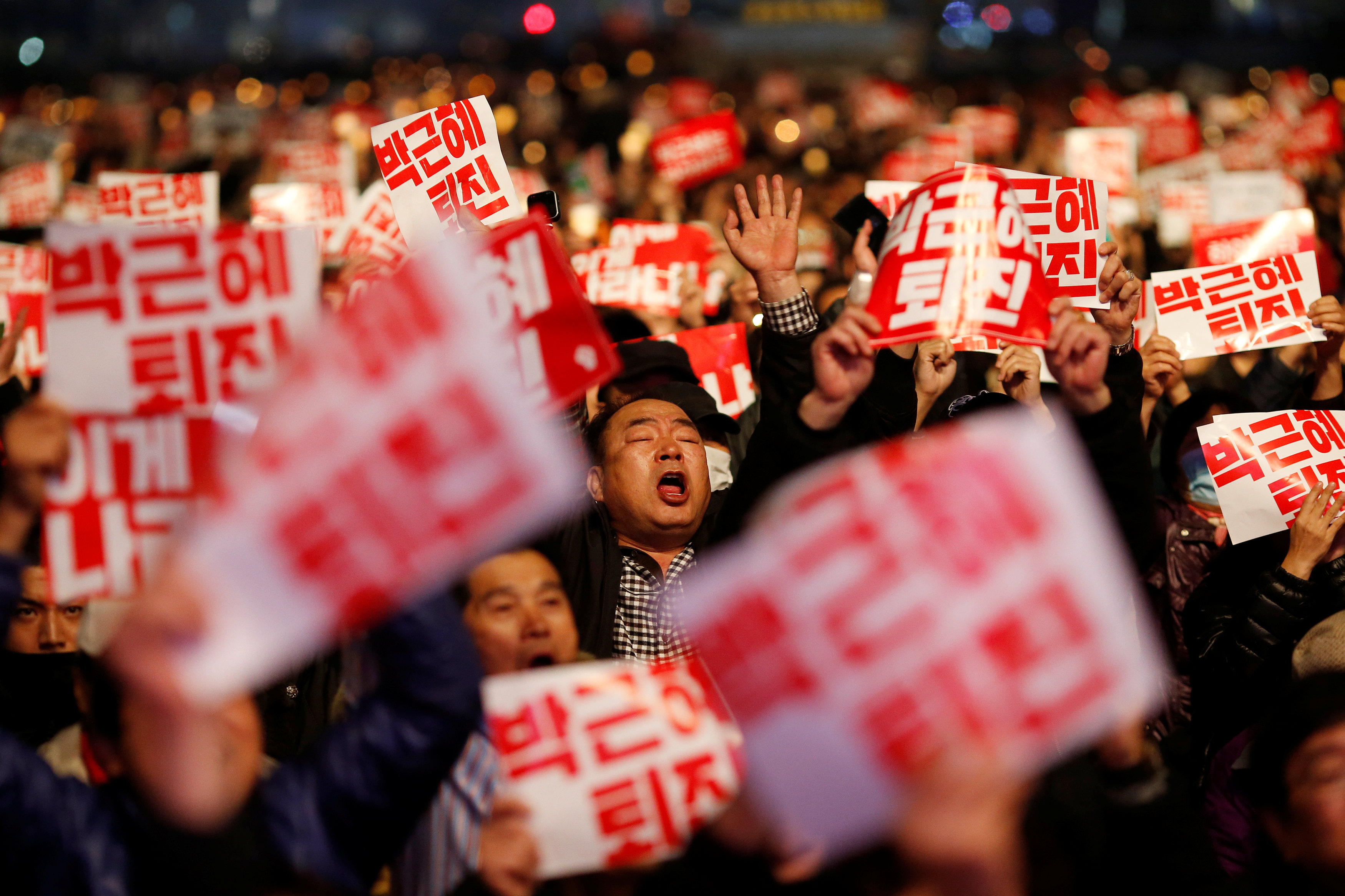 Tens of thousands of South Korean people chant slogans during a rally calling on embattled President Park Geun-hye to resign over a growing influence-peddling scandal in central Seoul, South Korea, November 5, 2016. The placards read, ,Step down Park Geun