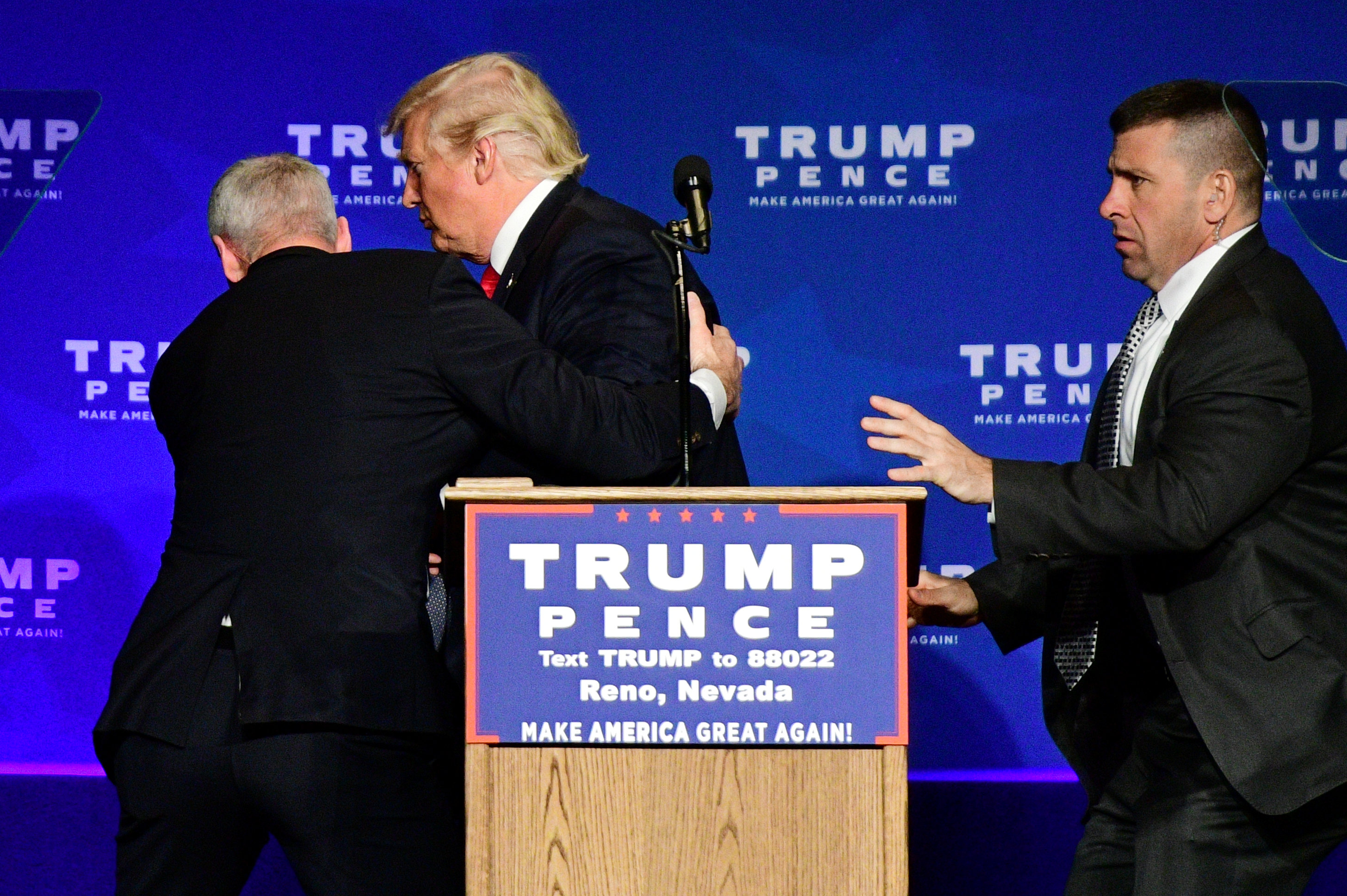 U.S. Republican presidential nominee Donald Trump is hustled off the stage by security agents after a perceived threat in the crowd, at a campaign rally in Reno, Nevada, U.S. November 5, 2016. REUTERS/Steven Styles FOR EDITORIAL USE ONLY. NO RESALES. NO A