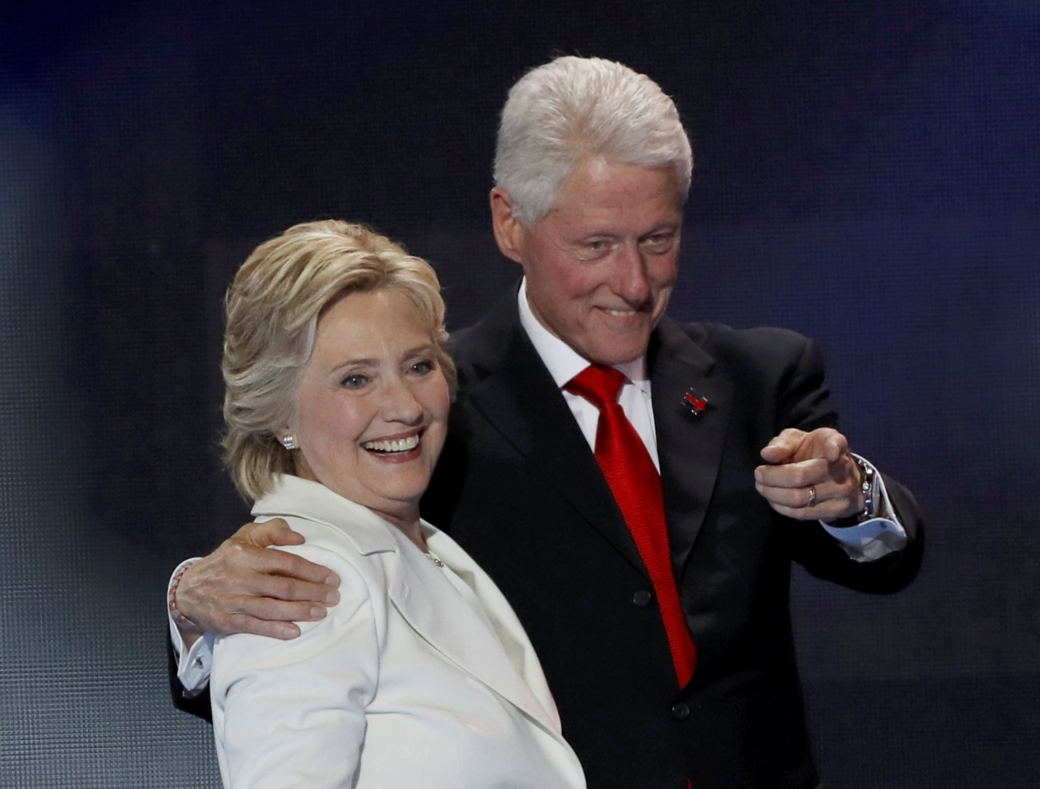 U.S. Democratic presidential nominee Hillary Clinton stands with her husband, former President Bill Clinton, after accepting the nomination on the final night of the Democratic National Convention in Philadelphia, Pennsylvania, U.S. July 28, 2016. REUTERS