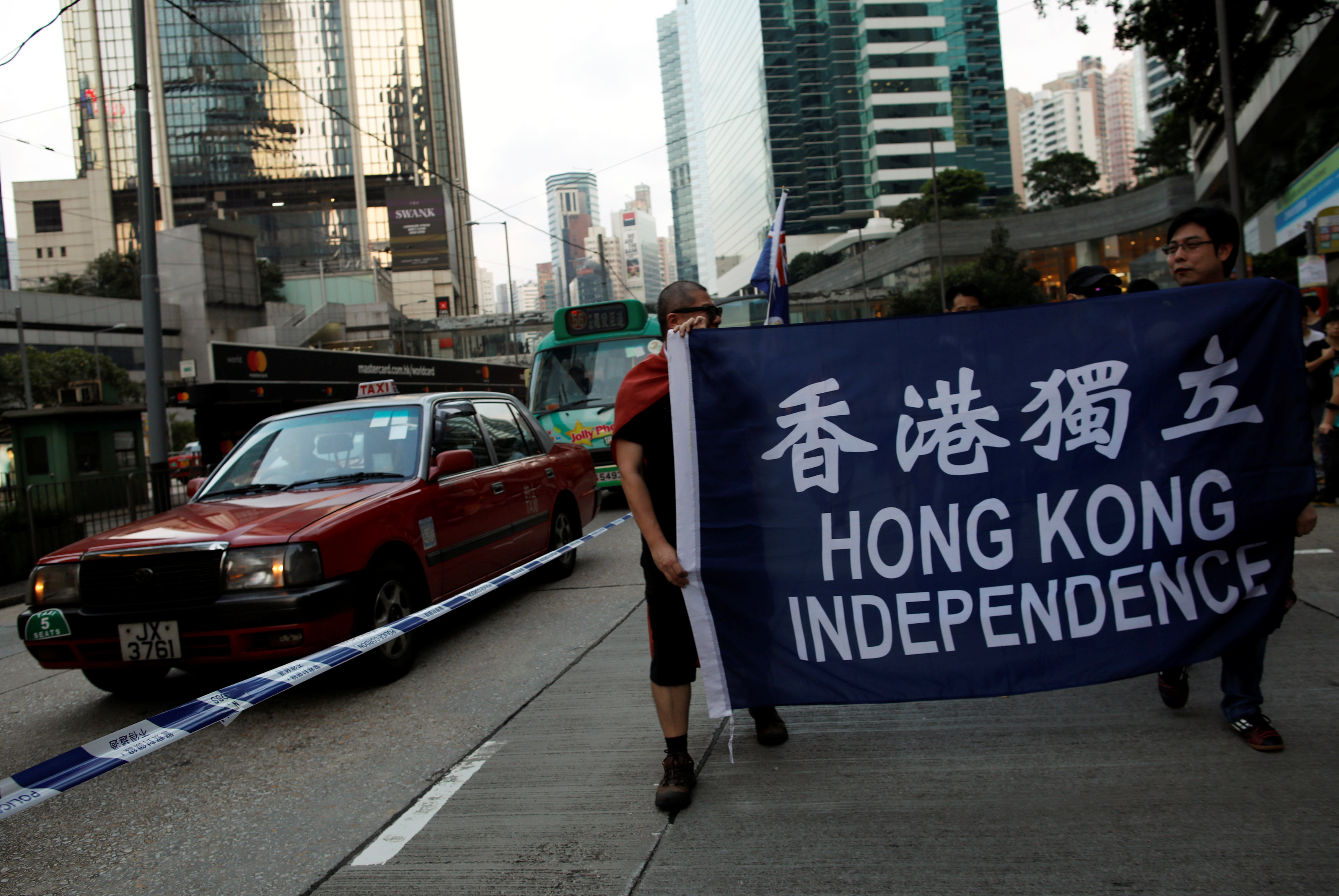 Demonstrators protest against what they call Beijing's interference over local politics and the rule of law, a day before China's parliament is expected to announce their interpretation of the Basic Law in light of two pro-independence lawmakers' oath-tak