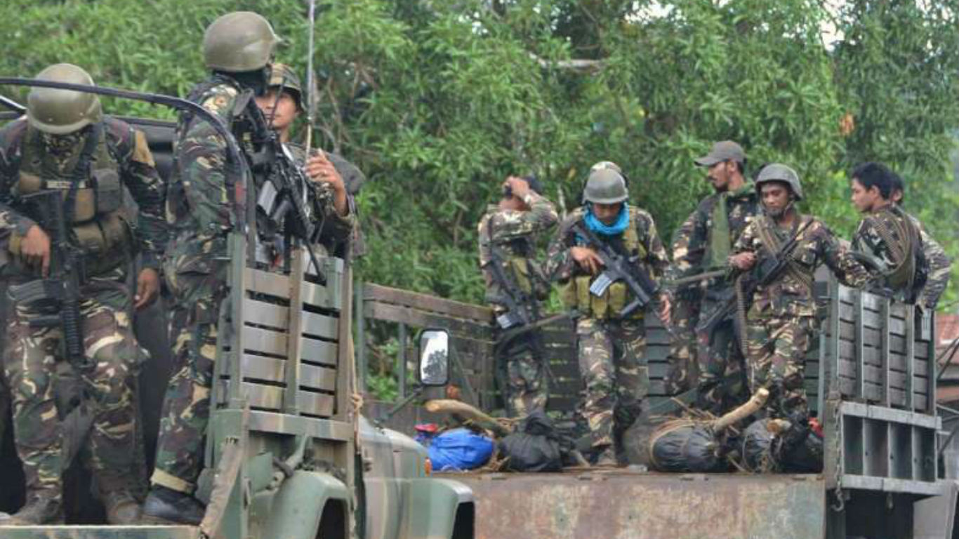 This photo taken on Aug 27, 2016 shows Philippine soldiers standing guard aboard a vehicle loaded with bodies of Abu Sayyaf members killed.PHOTO: AFPn