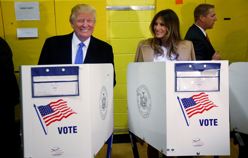 特朗普和太太梅拉妮亚在纽约一所票站内，用电子投票机投票。-路透社-