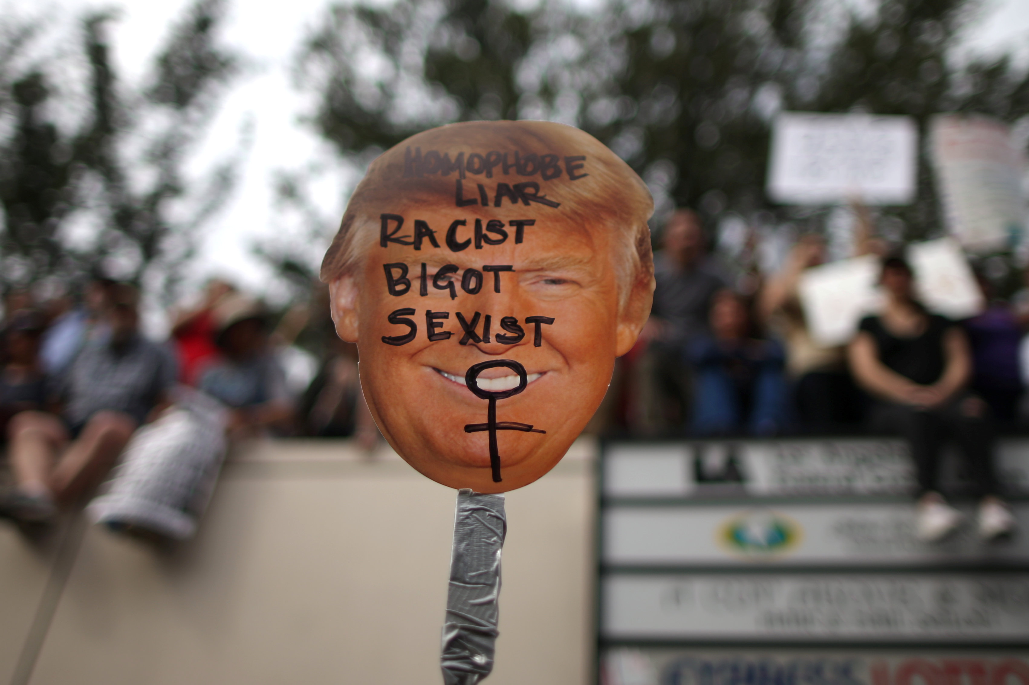 A protester holds a sign during a march and rally against the election of Republican Donald Trump as President of the United States in Los Angeles, California, U.S. November 12, 2016. REUTERS/Lucy Nicholsonn