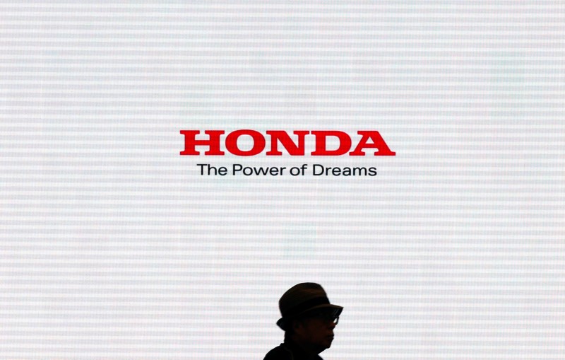 A man is silhouetted against a logo of Honda Motor at the company's showroom in Tokyo, Japan, May 13, 2016. REUTERS/Toru Hanai - RTX2E4NUn