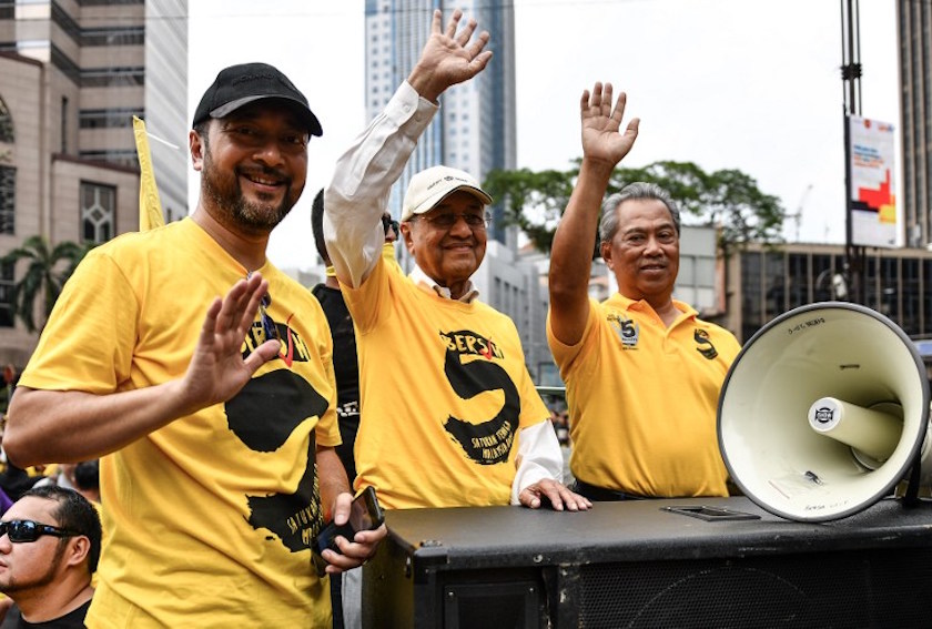 Tun Dr Mahathir Mohamad, his son Datuk Seri Mukhriz Mahathir and Tan Sri Muhyiddin Yassin wave during the Bersih 5 rally in Kuala Lumpur November 19, 2016. u00e2u20acu201d AFP pic