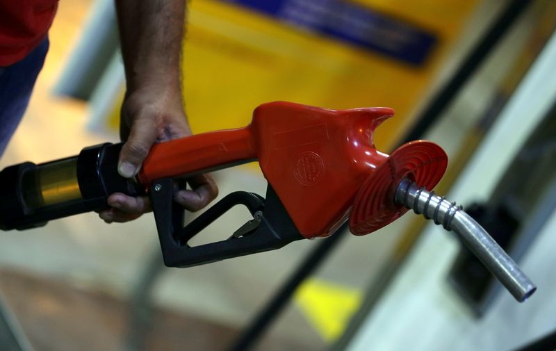 An employee holds a gas pump at a petrol station in Sao Paulo, Brazil, November 8, 2016. u00e2u20acu201d Reuters pic