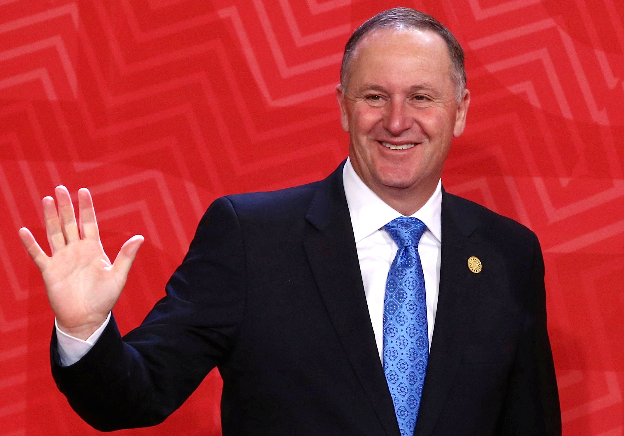 New Zealand's Prime Minister John Key waves to photographers during the APEC (Asia-Pacific Economic Cooperation) Summit in Lima, Peru, November 20, 2016. REUTERS/Mariana Bazo/File photon