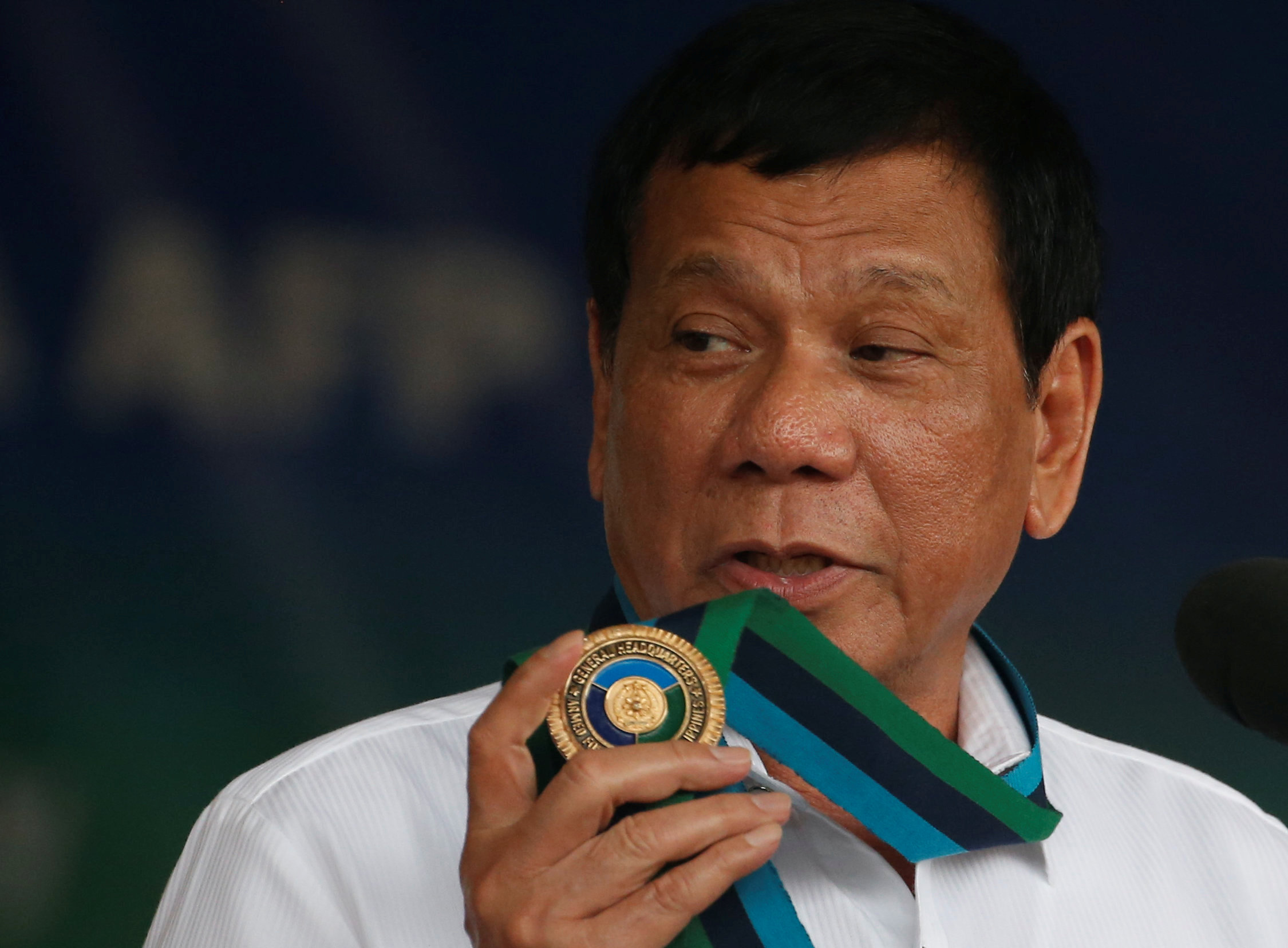 Philippine President Rodrigo Duterte holds an emblem of the Armed forces as he speaks at the change of command for the new Armed Forces chief at a military camp in Quezon city, Metro Manila, December 7, 2016. u00e2u20acu201d Reuters picn