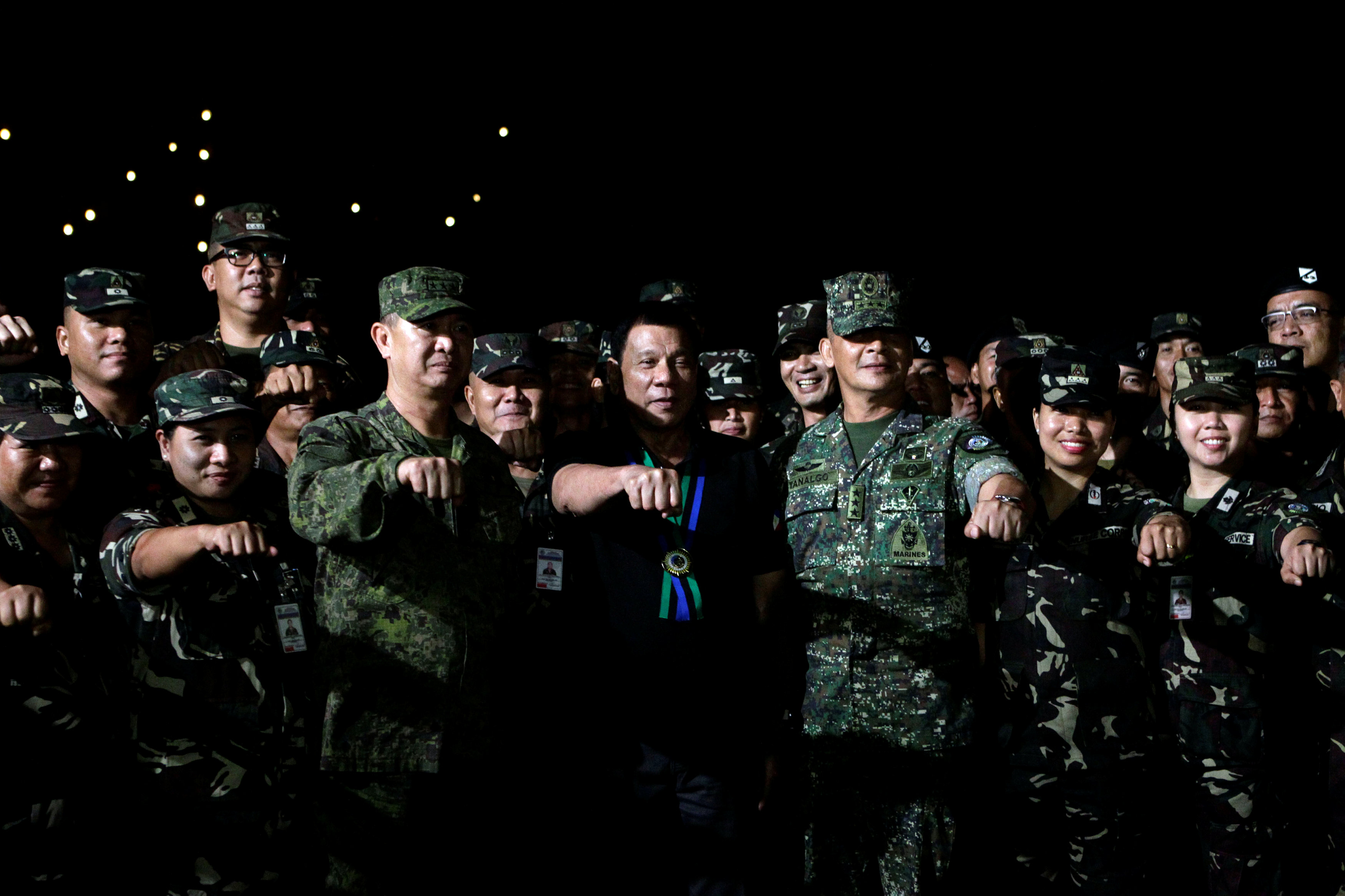 Philippine President Rodrigo Duterte makes a fist bump with soldiers during a visit to Camp Servillano S. Aquino in San Miguel, Tarlac, Philippines December 11, 2016. u00e2u20acu201d Reuters picn