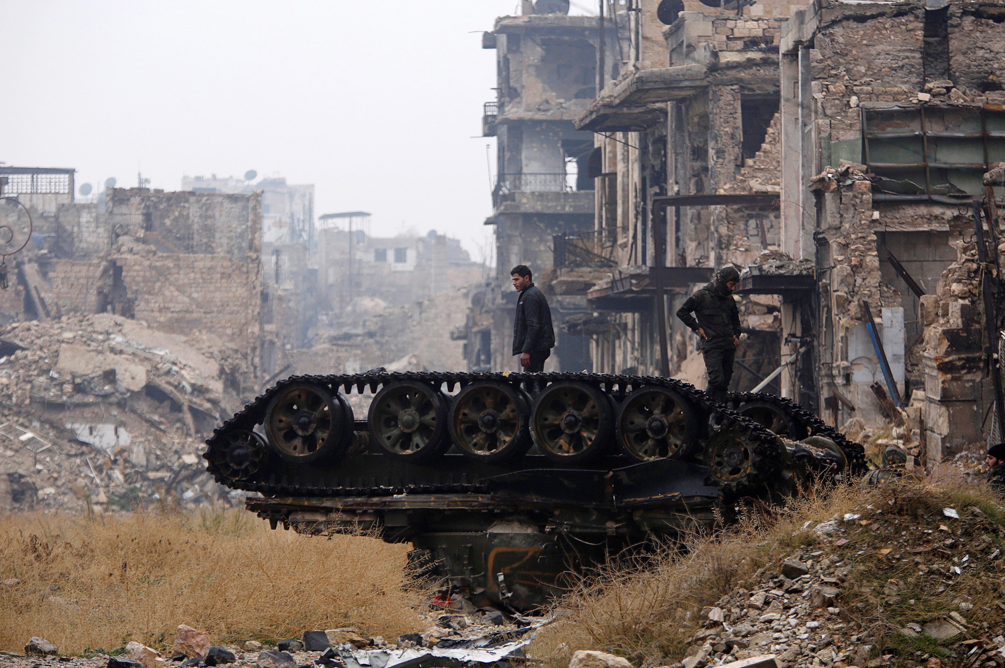 Forces loyal to Syria's President Bashar al-Assad stand atop a damaged tank near Umayyad mosque, in the government-controlled area of Aleppo, during a media tour, Syria December 13, 2016. REUTERS/Omar Sanadiki TPX IMAGES OF THE DAYn