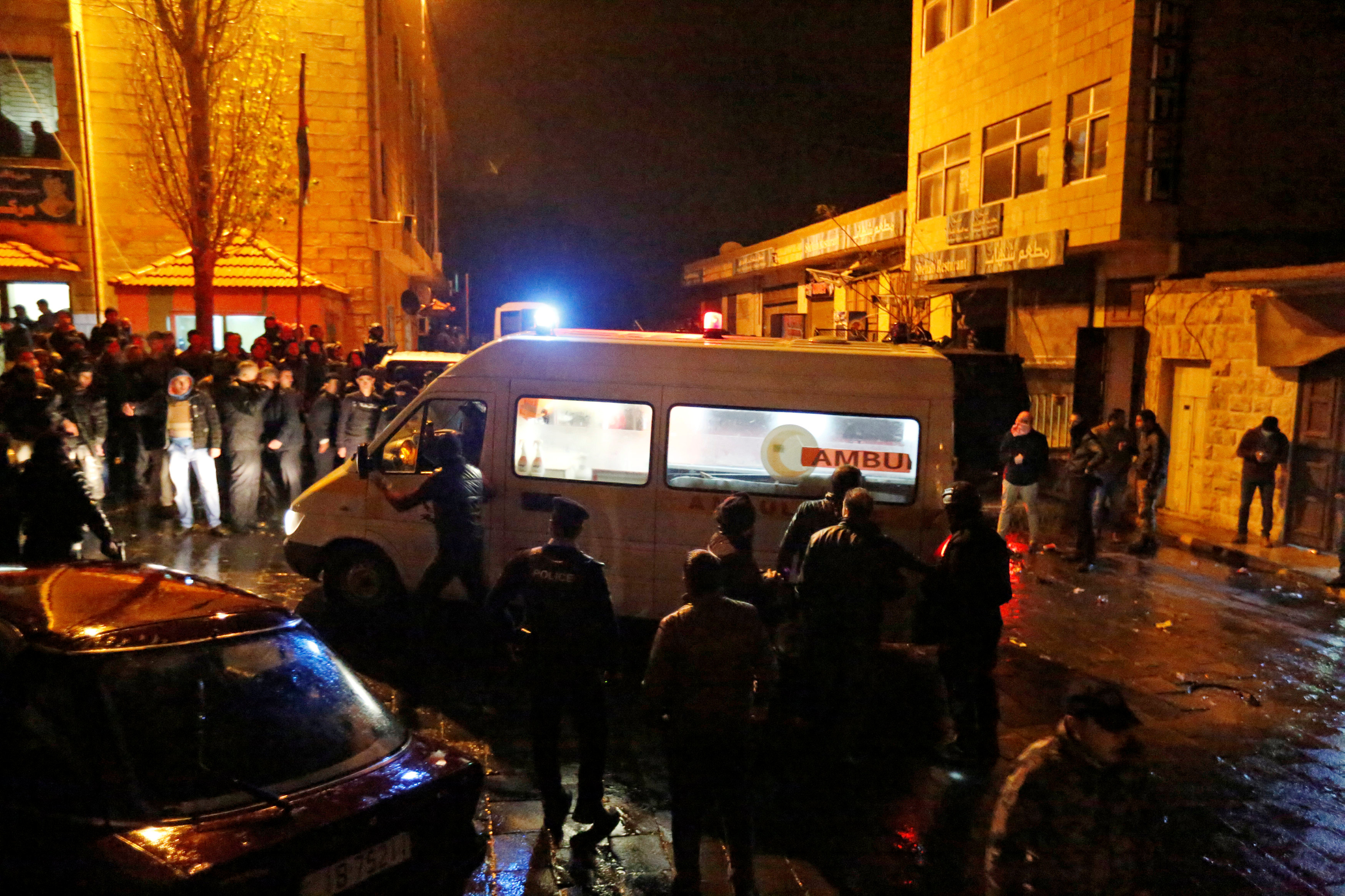 Jordanian policemen and an ambulance are seen in the vicinity of Karak Castle in the city of Karak, Jordan, December 18, 2016. REUTERS/Muhammad Hamedn