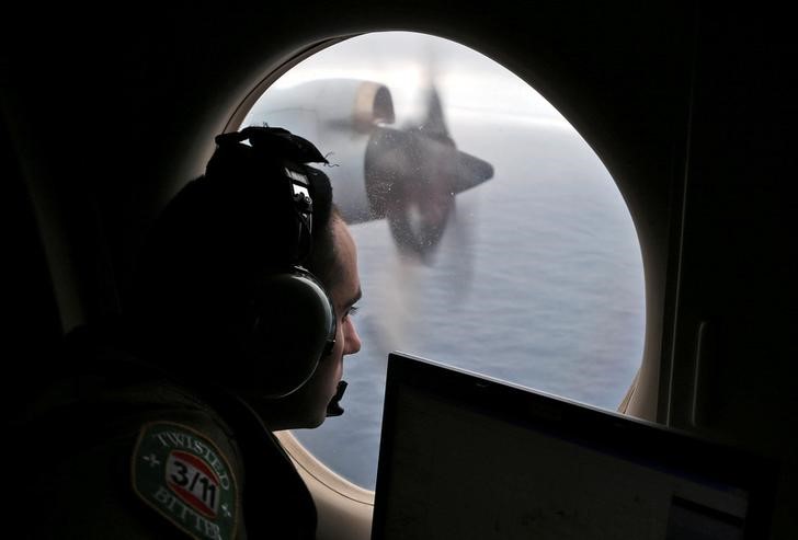 FILE PHOTO - Flight officer Rayan Gharazeddine looks out of a Royal Australian Air Force (RAAF) AP-3C Orion as it flies over the southern Indian Ocean during the search for missing Malaysian Airlines flight MH370 March 22, 2014. REUTERS/Rob Griffith/Pool/