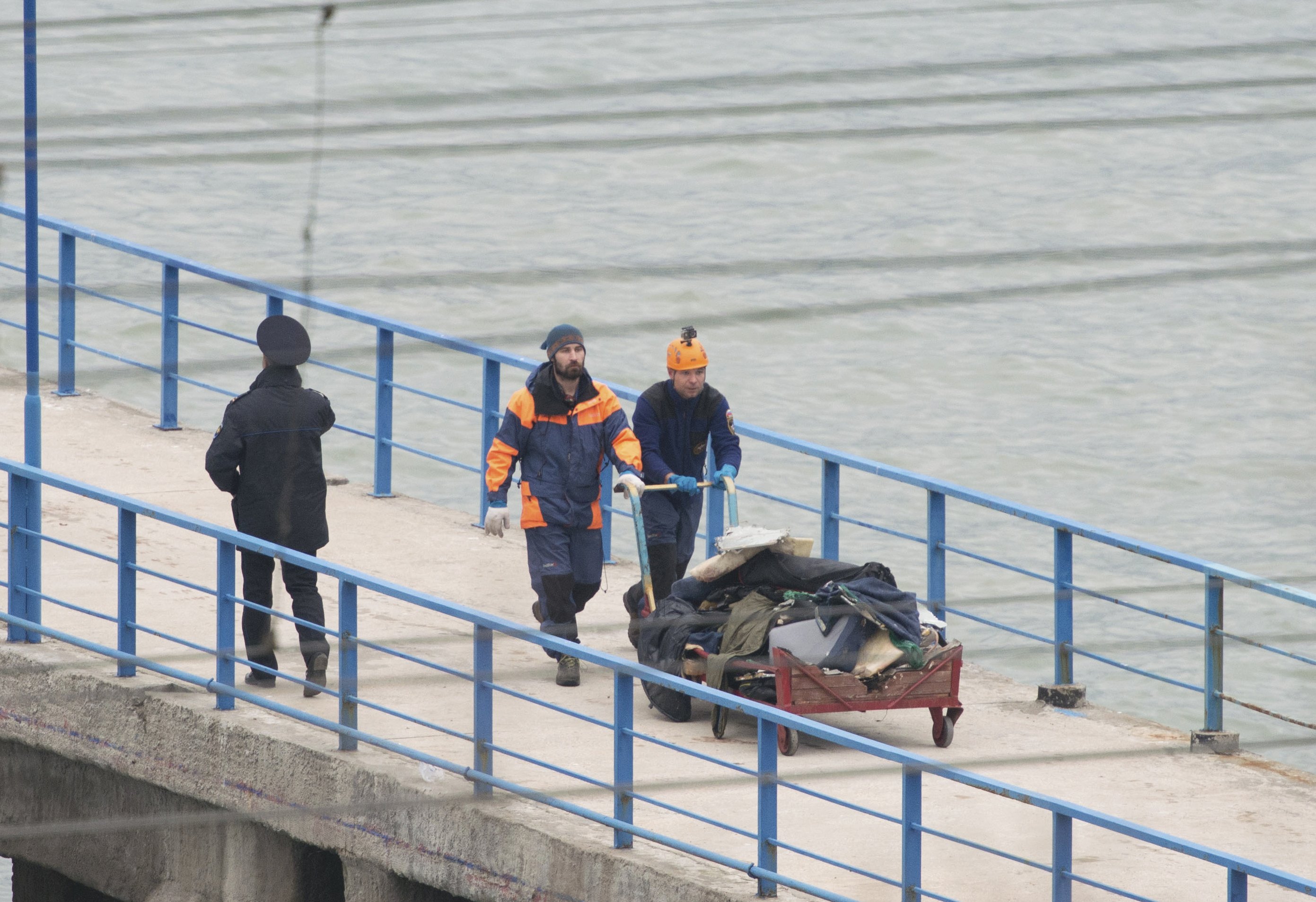 Russian Emergencies Ministry members push a cart with remains of Russian military Tu-154 plane which crashed into the Black Sea, at a quay in the Sochi suburb of Khosta, Russia, Russia December 25, 2016. REUTERS/Yevgeny Reutov FOR EDITORIAL USE ONLY. NO R