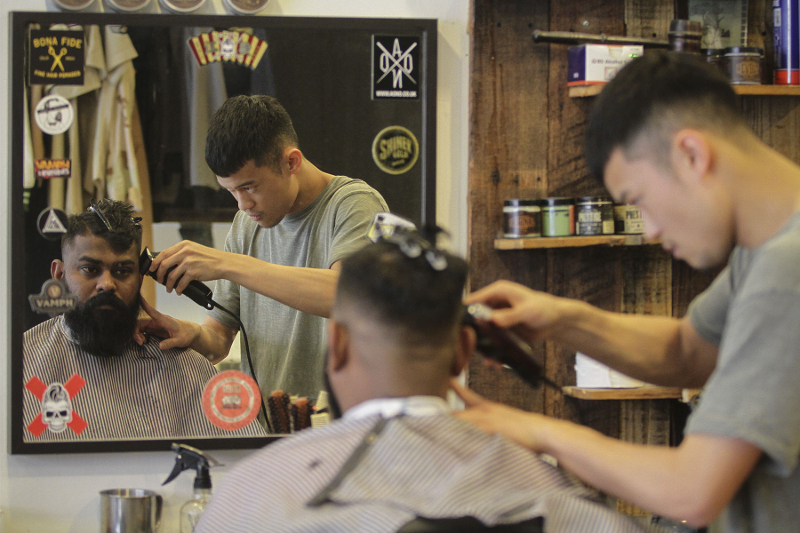A barber at Othrs giving his client a pompadour haircut. u00e2u20acu201d Picture by Yusof Mat Isa