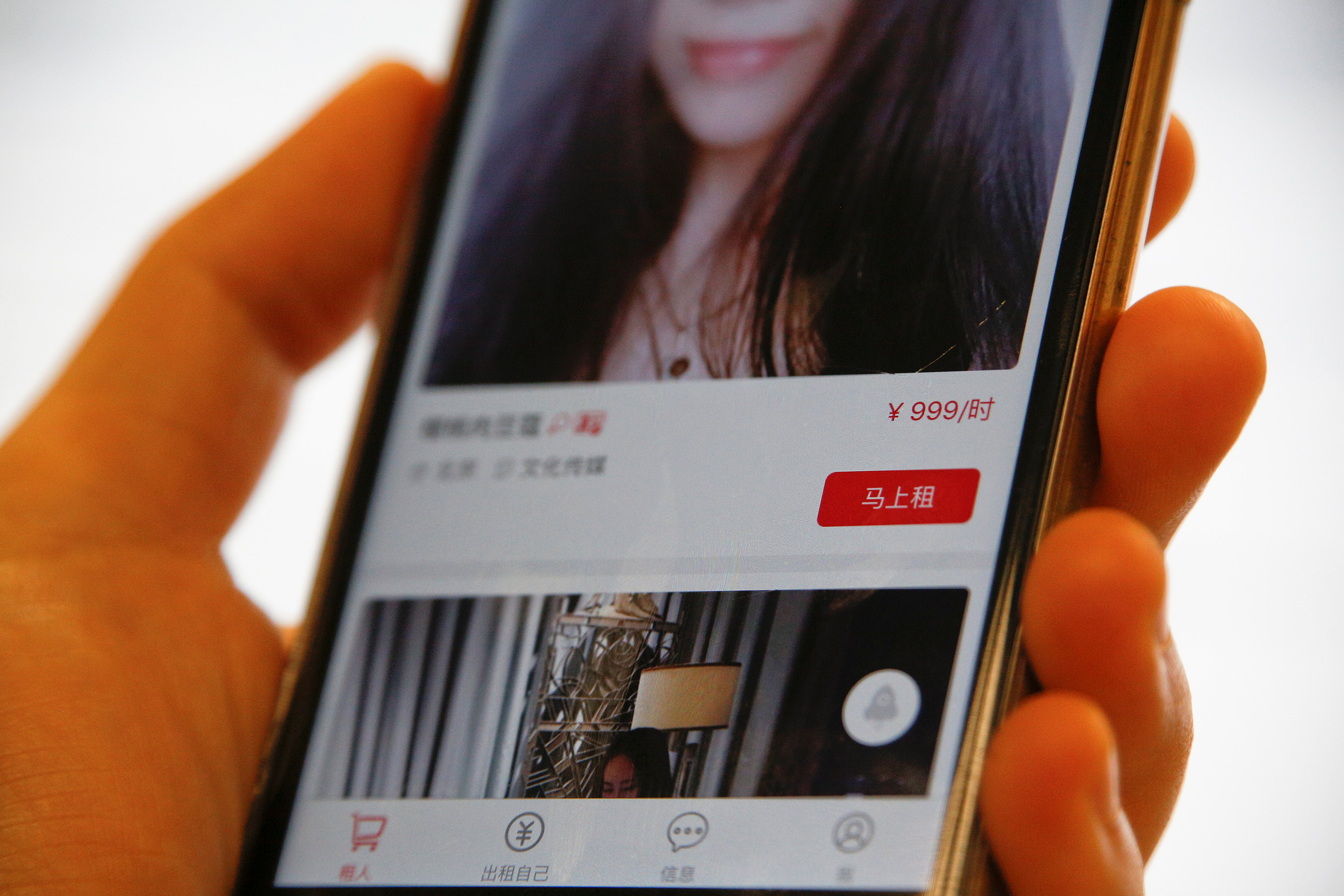 A page of a date-hiring app ,Hire Me Plz,, which says ,rent now for 999 yuan an hour,, is shown in this picture illustration in Beijing, China, January 26, 2017. REUTERS/Damir Sagolj/Illustration