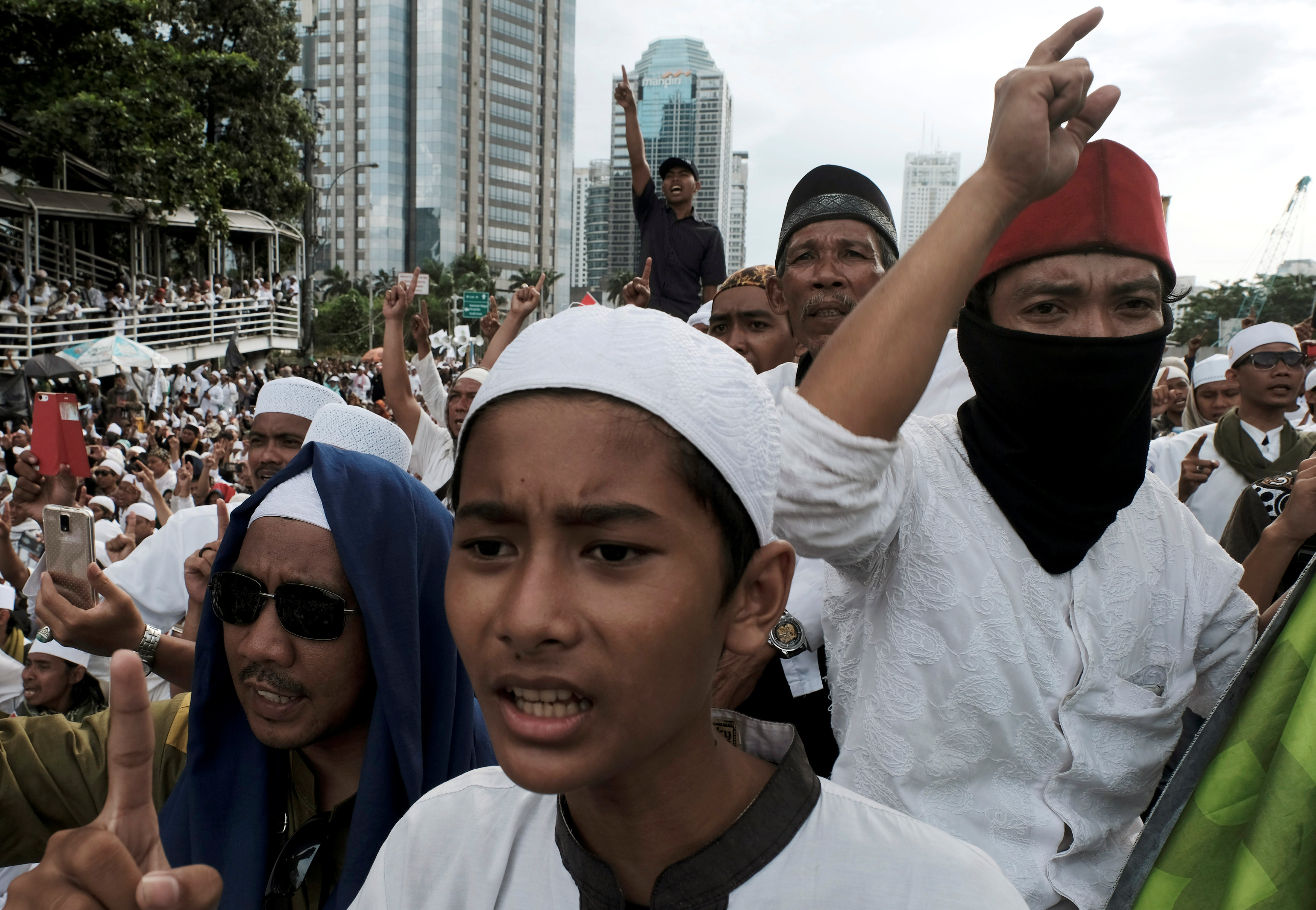 Members of the Islamic Defenders Front (FPI) shout slogans during a protest in front of the Indonesian police headquarters in Jakarta January 23, 2017. u00e2u20acu201d Reuters picn