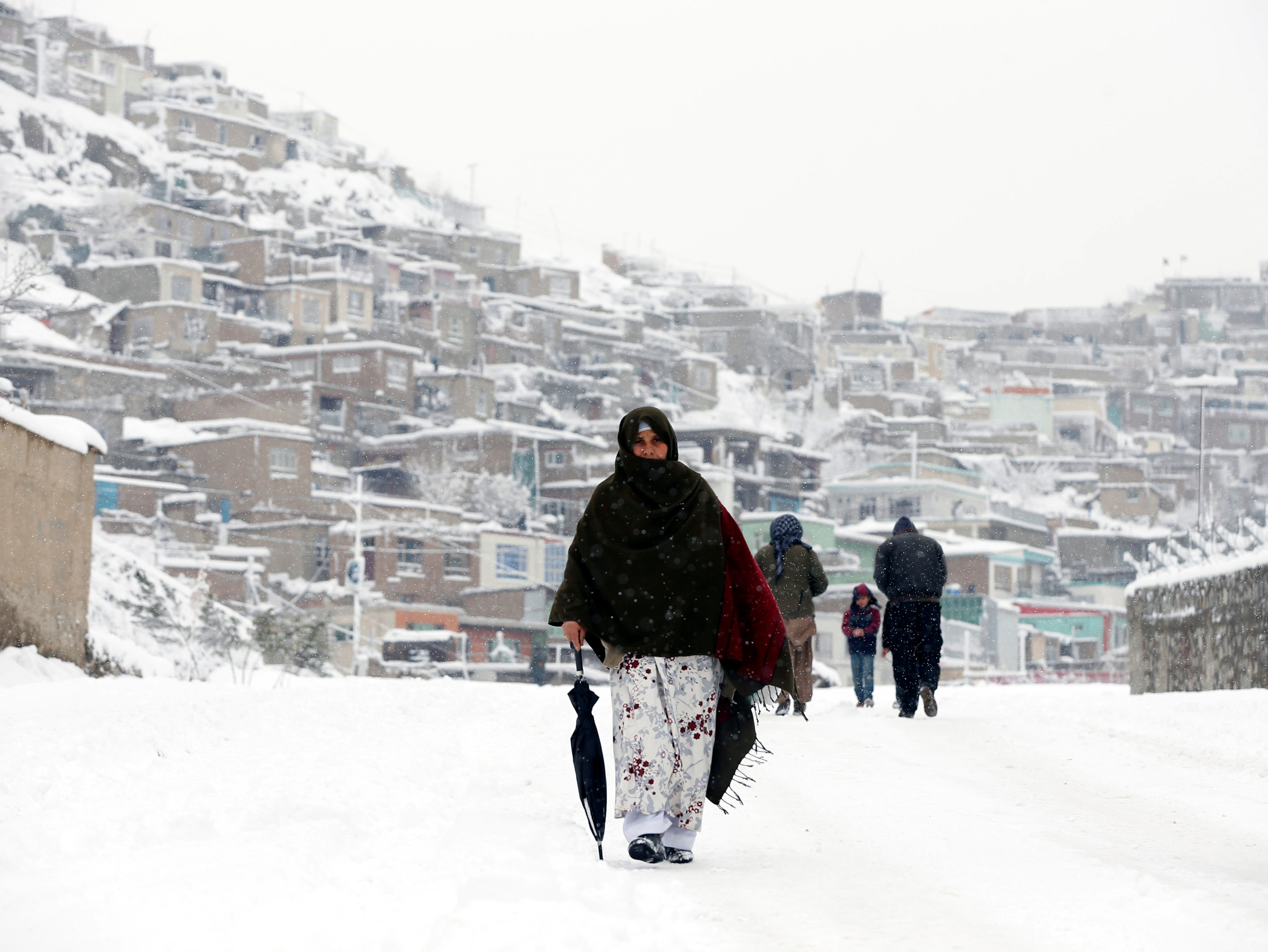 An Afghan woman walks on a snowy day in Kabul February 5, 2017. u00e2u20acu201d Reuters pic