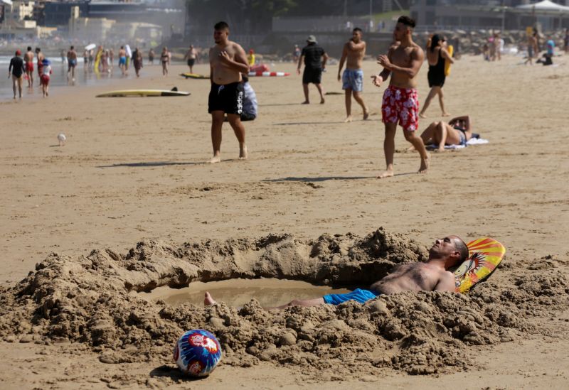 A man lays in a pool of sea water he dug into Sydney's North Cronulla Beach as Sydneysiders take refuge from sweltering conditions during a heatwave along Australia's east coast, February 11, 2017. u00e2u20acu201d Reuters pic