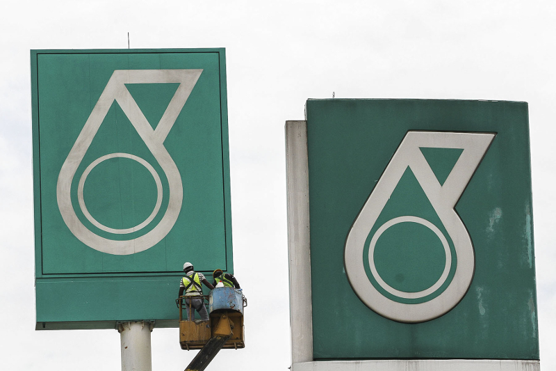 Workers work on a signage bearing a Petronas logo in Kuala Lumpur March 12, 2017. u00e2u20acu201d Picture by Yusof Mat Isan