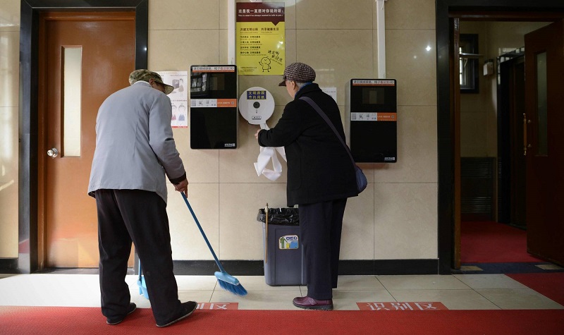A woman gets toilet paper from a dispenser next to two unused automatic toilet paper dispensers that use facial recognition technology at a public toilet at the Temple of Heaven in Beijing on March 21, 2017. u00e2u20acu201d AFP pic