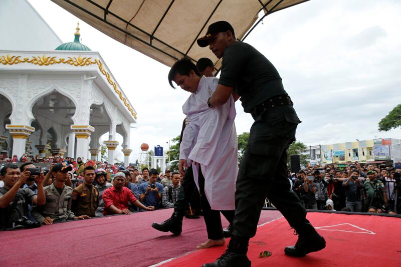 Syariah policemen hold an Indonesian man after being publicly caned for having gay sex, in Banda Aceh, Aceh province, Indonesia May 23, 2017. u00e2u20acu201d Reuter pic