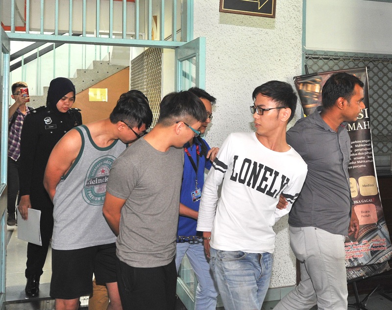 Police arrested JJPTR founder Johnson Lee (centre, in a gray t-shirt) and his two senior aides in Petaling Jaya May 16, 2017. 