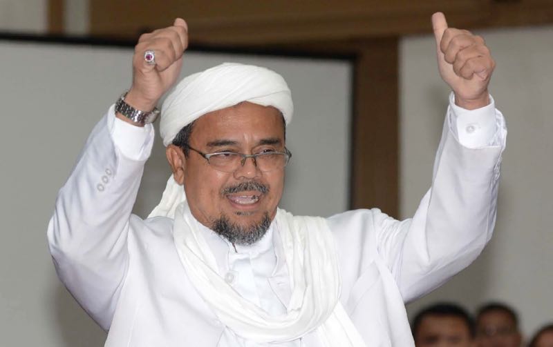 This file photograph taken on February 28, 2017 shows Indonesian firebrand cleric Rizieq Shihab gesturing as he arrives at court to testify in the blasphemy trial of Jakartau00e2u20acu2122s Christian governor Basuki Tjahaja Purnama in Jakarta. u00e2u20acu201d AFP pic