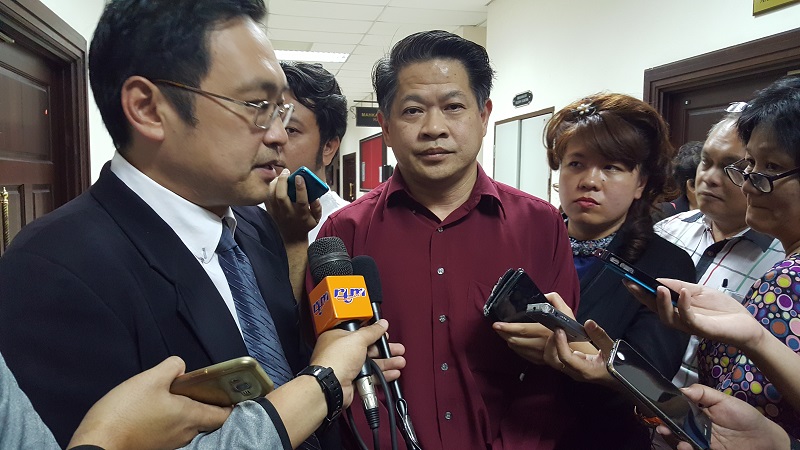 Restored Pujut state assemblyman Dr Ting Tiong Choon (with red shirt) speaking to reporters after the High Court has ruled that he was rightfully elected state assemblyman in Kuching June 17, 2017. u00e2u20acu201d Picture by Sulok Tawie