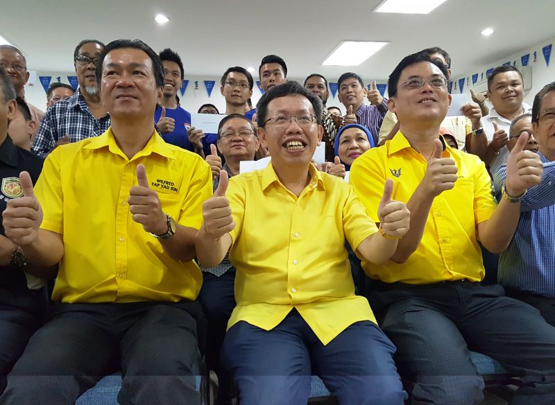Datuk Dr Sim Kui Hian (centre) giving the thumb up after handing over the government grants to non-governmental organisations at SUPP headquarters, June 3, 2017. u00e2u20acu2022 Picture by Sulok Tawie