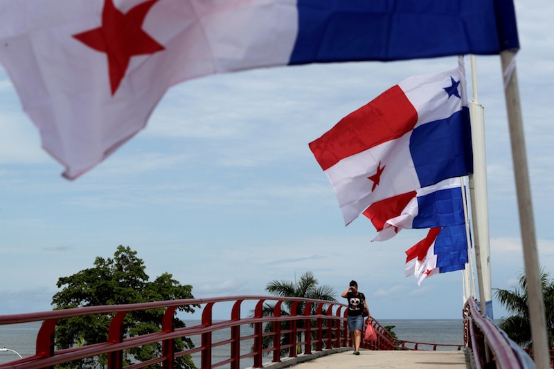 A woman walk pass next to Panama flags a day before the inauguration of the Panama Canal Expansion project, in Panama City, Panama June 25, 2016. u00e2u20acu201d Reuters pic 