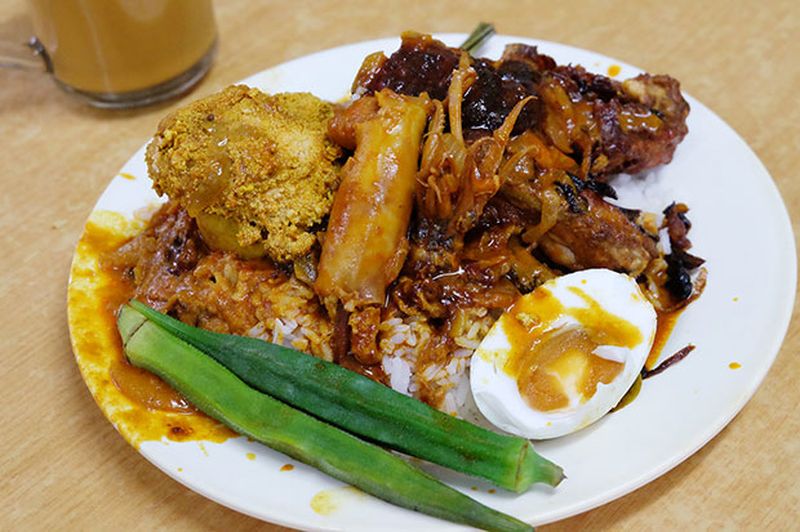 Nasi kandar Kampung Melayu is known for its delicious squid and flavourful curries. u00e2u20acu201d Pictures by KE Ooi