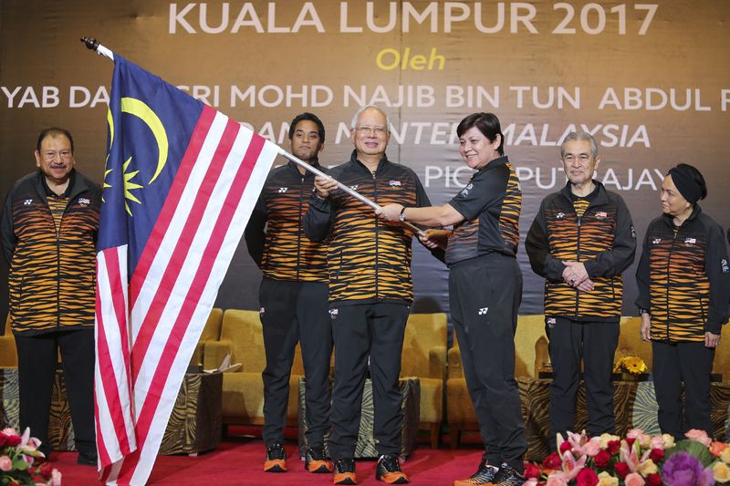Prime Minister Datuk Seri Najib Razak hands over the Jalur Gemilang to the SEA Games chef-de mission, Datuk Marina Chin (third right) during a ceremony at Putrajaya International Convention Centre, August 10, 2017. u00e2u20acu201d Picture by Yusof Mat Isa
