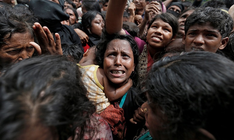 A woman reacts as Rohingya refugees wait to receive aid in Cox's Bazar, Bangladesh, September 21, 2017. REUTERS/Cathal McNaughton TPX IMAGES OF THE DAY