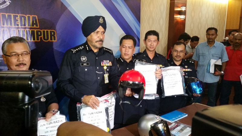 KL police chief Datuk Amar Singh shows the items that police seized including clothing and three helmets from the suspects of Thursdayu00e2u20acu2122s deadly fire at a tahfiz school. u00e2u20acu2022 Picture by Ida Lim