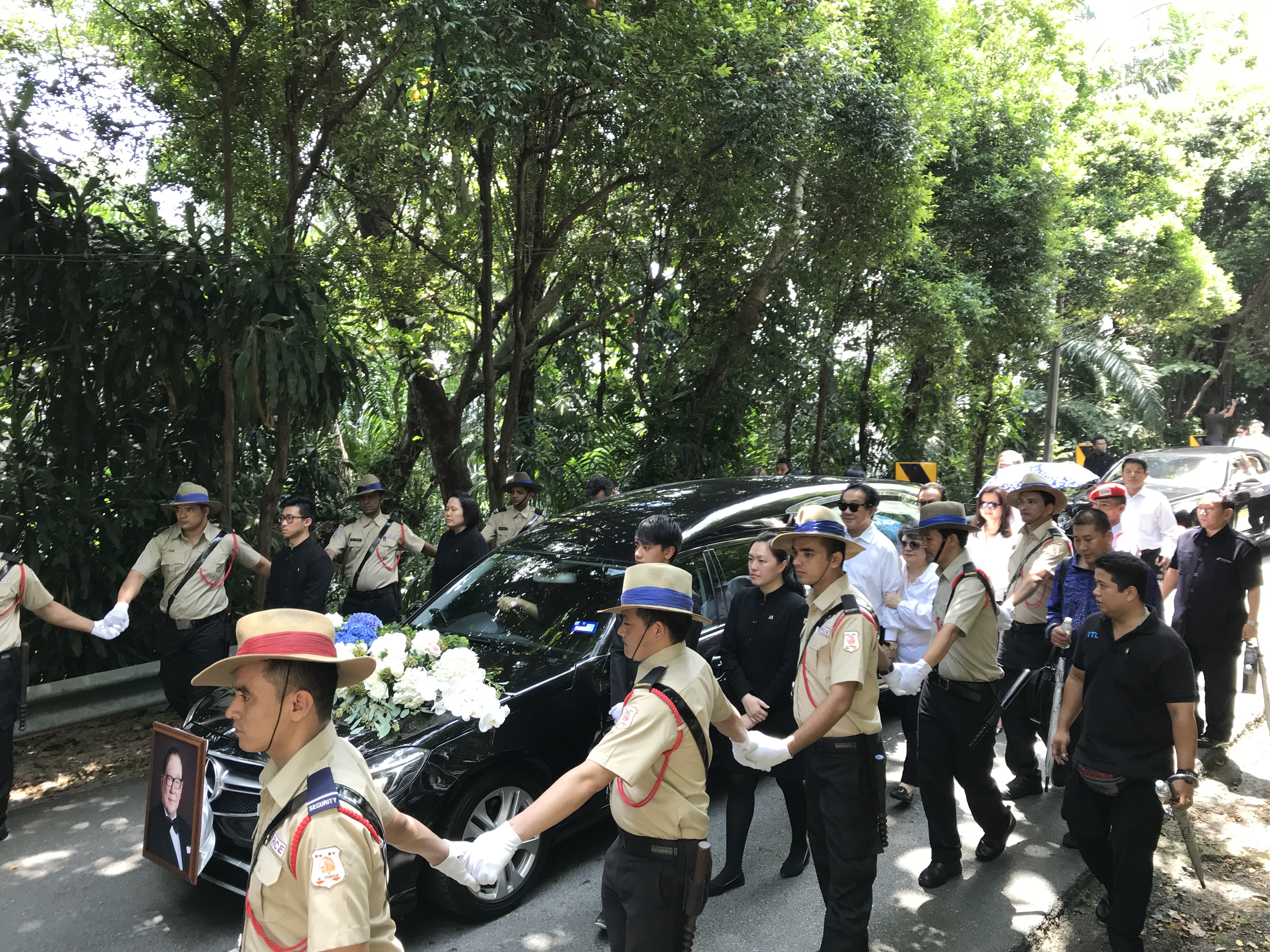 杨肃斌（戴墨镜者）与弟妹扶柩一路护送父亲杨忠礼。-M中文网-