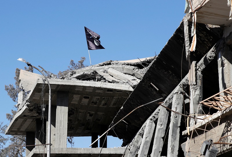 A flag of Islamic State militants is pictured above a destroyed house near the Clock Square in Raqqa, Syria October 18, 2017. u00e2u20acu201d Reuters pic