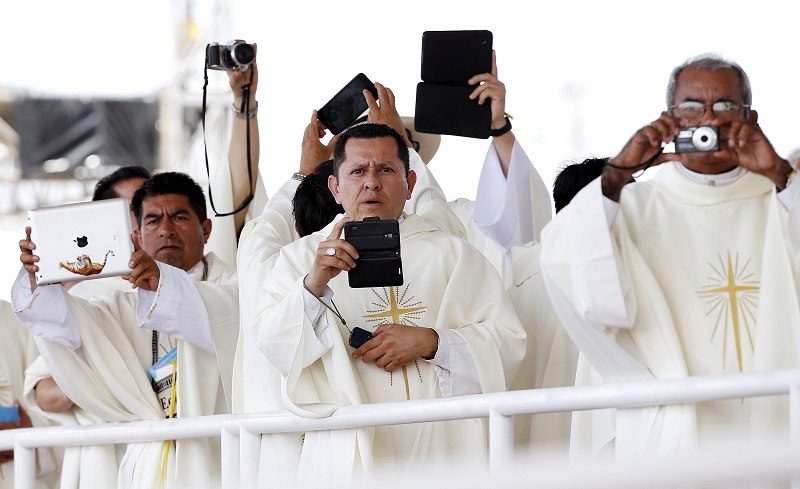 Bishops take pictures as Pope Francis leads a mass to mark the closing of the Catholic Jubilee Year of Mercy in Saint Peter's Square at the Vatican November 20, 2016. REUTERS/Stefano Rellandini/File photo